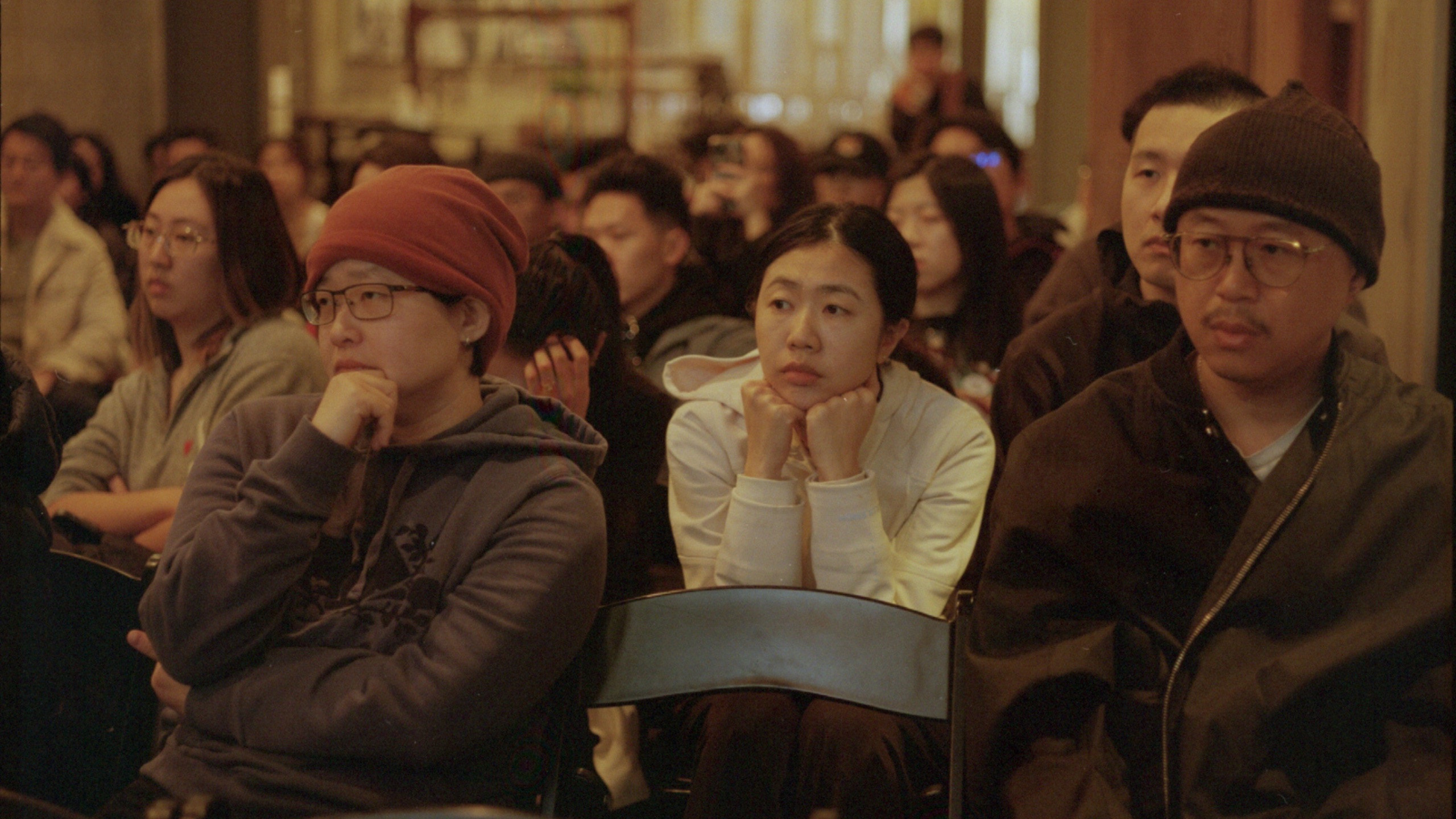 Audience members listening at an event